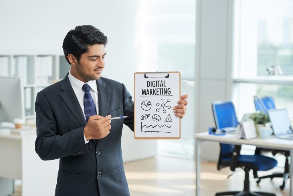 Punith Digital Marketing and Graphic Designing professional presenting digital marketing strategies, SEO, social media marketing, website design, and branding solutions in a modern office environment.